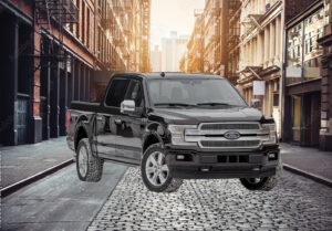 pick-up standing in a street surrounding by buildings