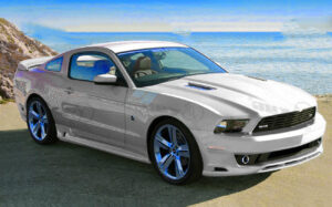 white mustang 2005 - 2014 in front of sea